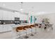 Modern kitchen with a large island, stylish bar stools, and stainless steel appliances at 1551 Flange Dr, Davenport, FL 33896