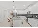 Spacious kitchen featuring white cabinets, a large island, and modern lighting fixtures at 1551 Flange Dr, Davenport, FL 33896