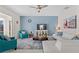 Bright living room with modern ceiling fan, blue accent wall, and white leather couch for a comfortable feel at 1551 Flange Dr, Davenport, FL 33896