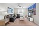 Spacious living room with large sectional couch, ceiling fan and two large NYC pictures on the walls at 1551 Flange Dr, Davenport, FL 33896