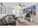 Comfortable living room with a large sectional couch, ceiling fan and two large NYC pictures on the walls at 1551 Flange Dr, Davenport, FL 33896