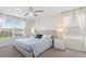Bright main bedroom with a plush bed, ceiling fan, and lots of natural light from two windows at 1551 Flange Dr, Davenport, FL 33896