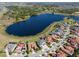 This aerial view shows a lakeside neighborhood with beautiful homes and lush landscaping at 15681 Panther Lake Dr, Winter Garden, FL 34787