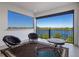 Spacious balcony features chairs and a table with a view of the beautiful lake at 15681 Panther Lake Dr, Winter Garden, FL 34787