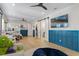 Expansive room features wood flooring, wainscotting, a ceiling fan, TV, and seating area at 15681 Panther Lake Dr, Winter Garden, FL 34787