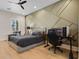 Comfortable bedroom with decorative wall trim, ceiling fan, wood floors, and a window with shutter at 15681 Panther Lake Dr, Winter Garden, FL 34787