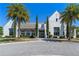 A beautiful clubhouse in a gated community, enhanced by meticulously maintained landscaping and palm trees at 15681 Panther Lake Dr, Winter Garden, FL 34787