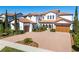 Stunning two-story Mediterranean-style home with a brick driveway and lush landscaping at 15681 Panther Lake Dr, Winter Garden, FL 34787