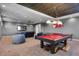 Game room area boasts a pool table and a large television for entertainment at 15681 Panther Lake Dr, Winter Garden, FL 34787