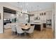 Open kitchen and dining area with modern lighting, stainless appliances, and a large island at 15681 Panther Lake Dr, Winter Garden, FL 34787