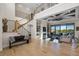 Spacious living room with a soaring ceiling, statement staircase, and natural light at 15681 Panther Lake Dr, Winter Garden, FL 34787