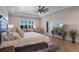Bright main bedroom with tray ceilings, hardwood floors, and a sitting area at 15681 Panther Lake Dr, Winter Garden, FL 34787