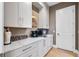 Walk-in pantry features white cabinets, quartz countertops, and ample storage space at 15681 Panther Lake Dr, Winter Garden, FL 34787