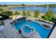 Aerial view of a private pool with a rock waterfall feature and attached spa at 15681 Panther Lake Dr, Winter Garden, FL 34787
