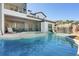 Gorgeous pool with waterfall feature, integrated spa, and screened-in lanai; the perfect outdoor retreat at 15681 Panther Lake Dr, Winter Garden, FL 34787