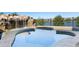 Close up view of the in-ground spa with a stone waterfall feature next to the pool at 15681 Panther Lake Dr, Winter Garden, FL 34787