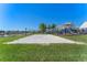A well-maintained sand volleyball court, perfect for recreational fun in a lakeside community at 15681 Panther Lake Dr, Winter Garden, FL 34787