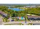 Aerial view of the community pool, clubhouse, tennis court, and surrounding landscape at 16241 Old Ash Loop, Orlando, FL 32828