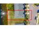 Aerial view of the townhome showing proximity to pond, landscaping, and parking at 16241 Old Ash Loop, Orlando, FL 32828