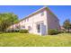 Exterior backyard view showcases a grassy lawn, privacy fence and patio at 16241 Old Ash Loop, Orlando, FL 32828