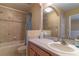 Clean bathroom with a large mirror and vanity with a shower-tub combo at 16241 Old Ash Loop, Orlando, FL 32828