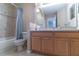 Well-lit bathroom with a vanity, large mirror, and a shower-tub combo at 16241 Old Ash Loop, Orlando, FL 32828