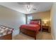 Comfortable bedroom with a wooden bed frame, ceiling fan, and side tables at 16241 Old Ash Loop, Orlando, FL 32828