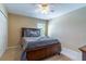 Relaxing bedroom featuring a dark wood bed frame and large window at 16241 Old Ash Loop, Orlando, FL 32828