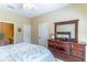 Comfortable bedroom with a wooden dresser and mirror, and an ensuite bathroom at 16241 Old Ash Loop, Orlando, FL 32828