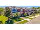 Row of colorful two-story townhomes with lush landscaping, brick paved driveways, and well-manicured lawns at 16241 Old Ash Loop, Orlando, FL 32828