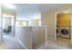 Upstairs hallway leading to a laundry room and a sitting area at 16241 Old Ash Loop, Orlando, FL 32828