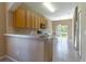 Kitchen featuring wooden cabinets, a breakfast bar, and a dining area with sliding glass doors to the outdoors at 16241 Old Ash Loop, Orlando, FL 32828