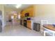 Spacious kitchen with wooden cabinets, stainless steel appliances, and an open layout leading to the dining area at 16241 Old Ash Loop, Orlando, FL 32828