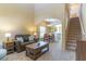 Inviting living room with high ceilings, archways, neutral carpet, and comfortable seating area at 16241 Old Ash Loop, Orlando, FL 32828