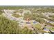 Wide aerial shot of single Gathering home in a neighborhood surrounded by lots of green trees at 17236 Sw 44Th Cir, Ocala, FL 34473