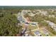 Birds eye view of a single Gathering home in a neighborhood near green trees and utility lines at 17236 Sw 44Th Cir, Ocala, FL 34473