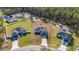 Aerial view of a single Gathering home in a quiet neighborhood surrounded by lush green trees at 17236 Sw 44Th Cir, Ocala, FL 34473