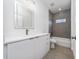 Modern bathroom with gray tile, tub, and white vanity at 17236 Sw 44Th Cir, Ocala, FL 34473