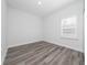 Cozy bedroom featuring a window with wood-look floors at 17236 Sw 44Th Cir, Ocala, FL 34473
