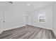 This bedroom features light gray vinyl flooring, white walls, and a window with horizontal blinds at 17236 Sw 44Th Cir, Ocala, FL 34473