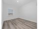 Bright bedroom with a window and wood-look floors at 17236 Sw 44Th Cir, Ocala, FL 34473
