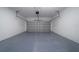 Spacious two-car garage with white brick walls, a gray epoxy floor, and an automatic door at 17236 Sw 44Th Cir, Ocala, FL 34473