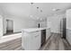 Open kitchen design with a large island, stainless steel appliances, and wood-look flooring at 17236 Sw 44Th Cir, Ocala, FL 34473