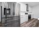 Modern kitchen featuring stainless steel appliances, white cabinets, and stylish wood flooring at 17236 Sw 44Th Cir, Ocala, FL 34473