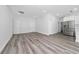 A modern open living space offers light wood flooring and an adjacent kitchen with white cabinets at 17236 Sw 44Th Cir, Ocala, FL 34473