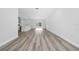 An open-concept living space features light wood flooring, recessed lighting, and a kitchen with white cabinets at 17236 Sw 44Th Cir, Ocala, FL 34473