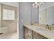 Modern bathroom with a double sink vanity, granite counters and a tiled shower area with a glass window at 2007 Royal Bay Blvd # 144, Kissimmee, FL 34746