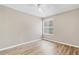 Bright bedroom with wood-look floors, a ceiling fan, and natural light streaming through the window at 2007 Royal Bay Blvd # 144, Kissimmee, FL 34746
