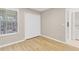 Bedroom with wood-look floors, double closet, and a view to the laundry room at 2007 Royal Bay Blvd # 144, Kissimmee, FL 34746