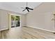Airy bedroom showcasing vaulted ceilings, wood-look floors, and sliding glass doors leading to the balcony at 2007 Royal Bay Blvd # 144, Kissimmee, FL 34746